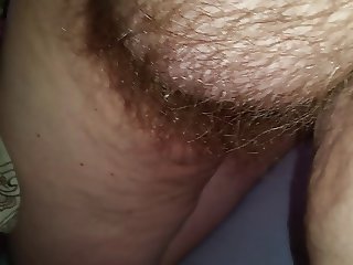 looking at her hanging tits, hairy pussy as she wanks me